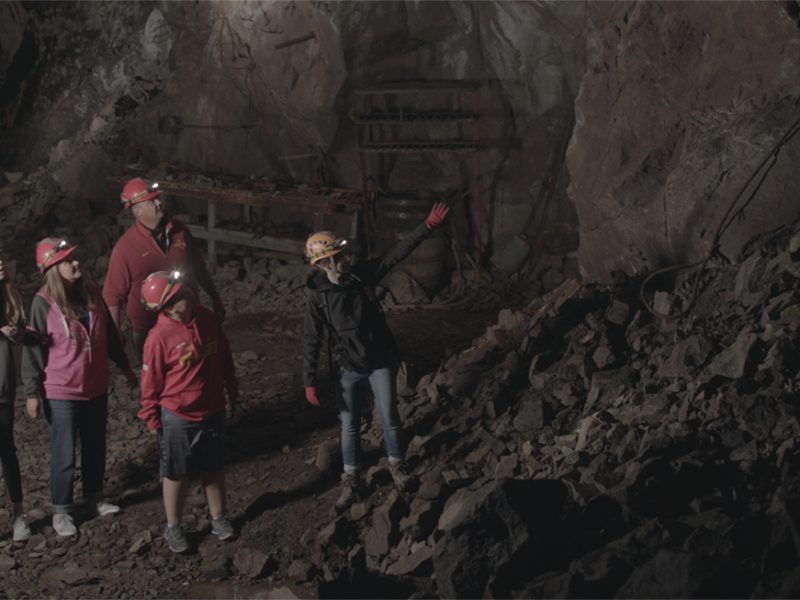 Tour-Guide-Pointing-at-Features-Underground-in-the-Adventure-Mine